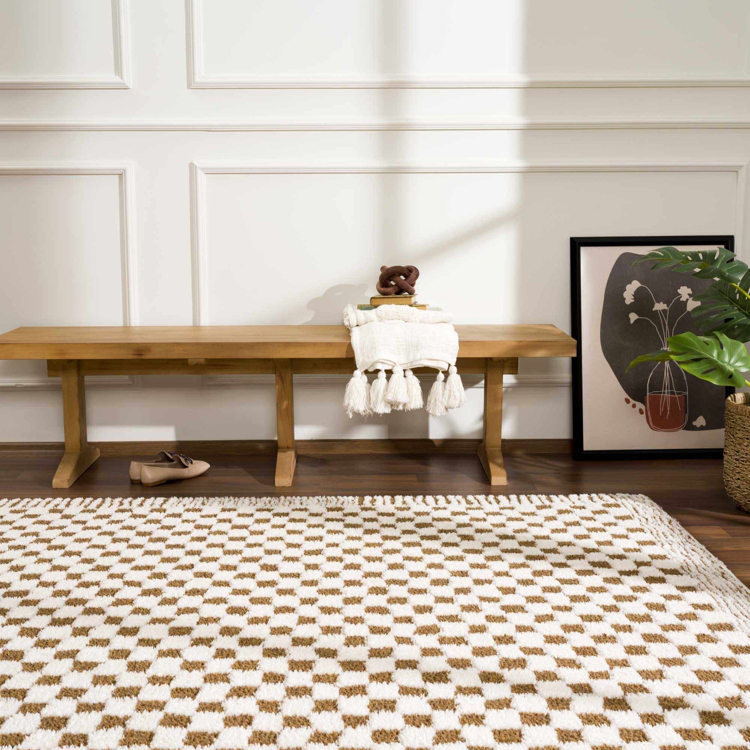 Entryway with a Leryn Brown Checkered Plush Rug, wood bench, art, and neutral decor. Roomscene-Rectangle