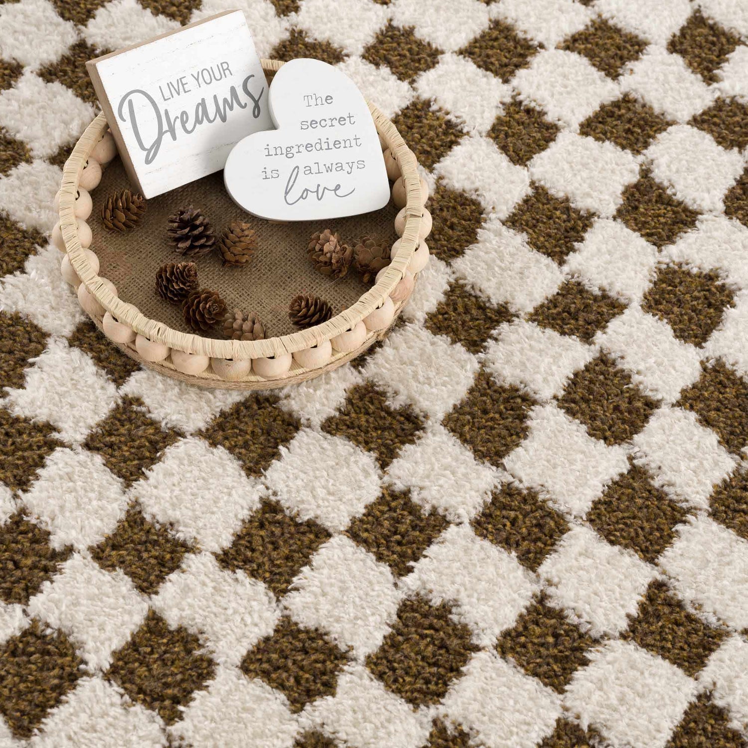 Close-up of the Leryn Brown Checkered Plush Rug, featuring a geometric brown and ivory checkerboard pattern and soft texture. Styleshot