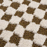 Close-up of the plush Leryn Brown Checkered Rug. Features a brown and ivory checkered pattern with a soft, textured pile. Texture