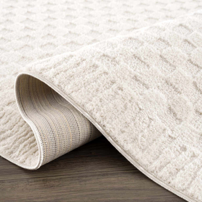 Close-up of the Leryn Ivory Checkered Area Rug showing its soft texture and geometric checkered pattern on a wood floor. Fold