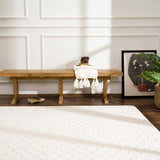 Entryway with a light wood bench and ivory Leryn Checkered Area Rug on a dark wood floor. Roomscene-Rectangle