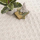 Close-up of the Leryn Ivory Checkered Area Rug, showing its geometric pattern and soft, textured weave in beige and off-white tones. Styleshot