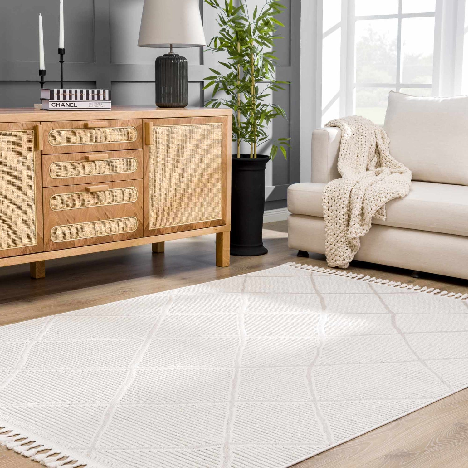 Living room scene with a light wood cabinet, sofa, and the beige geometric Lova Area Rug. Roomscene-Rectangle