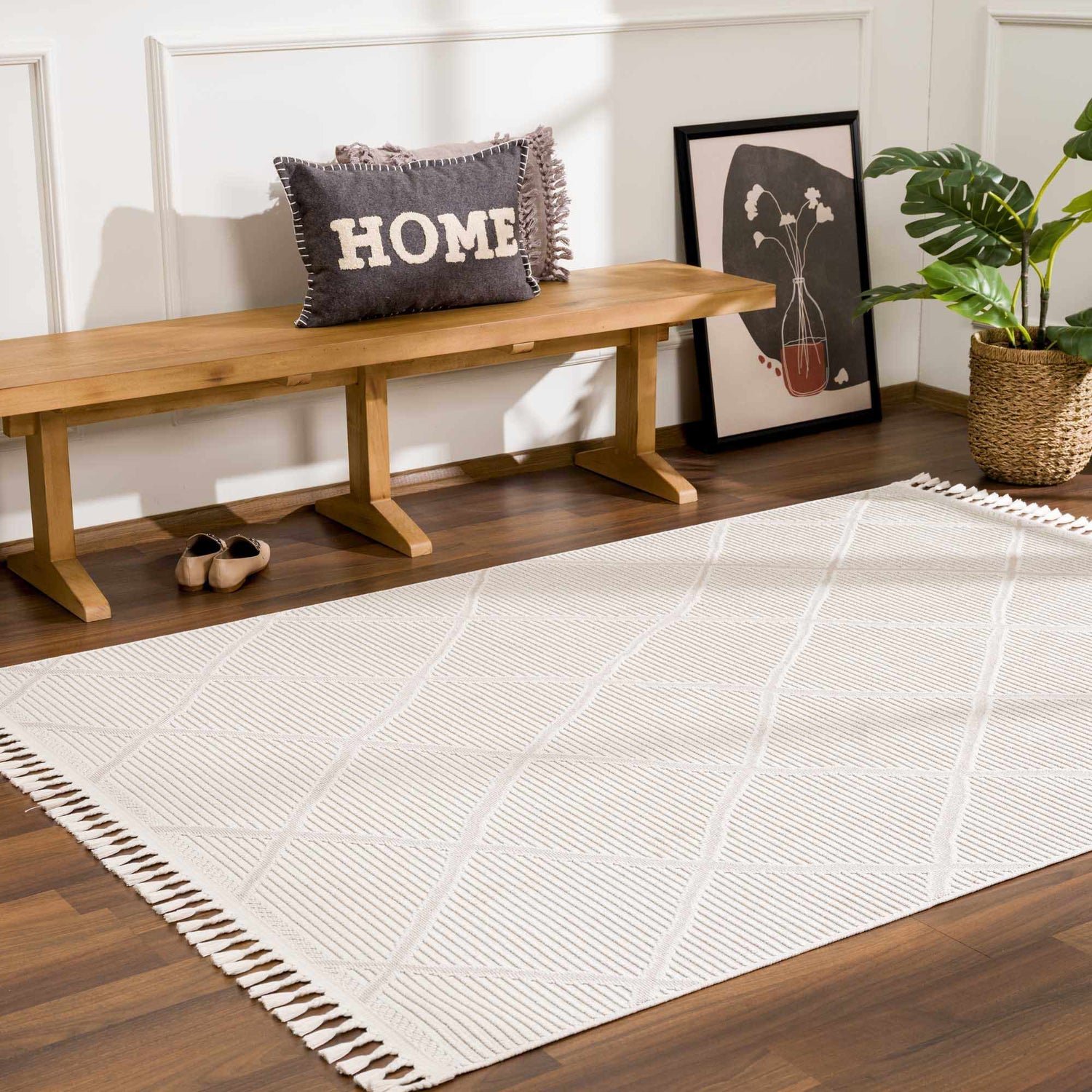 Entryway scene with beige Lova Area Rug, wood bench, throw pillow, and plant. Farmhouse style. Roomscene-Rectangle