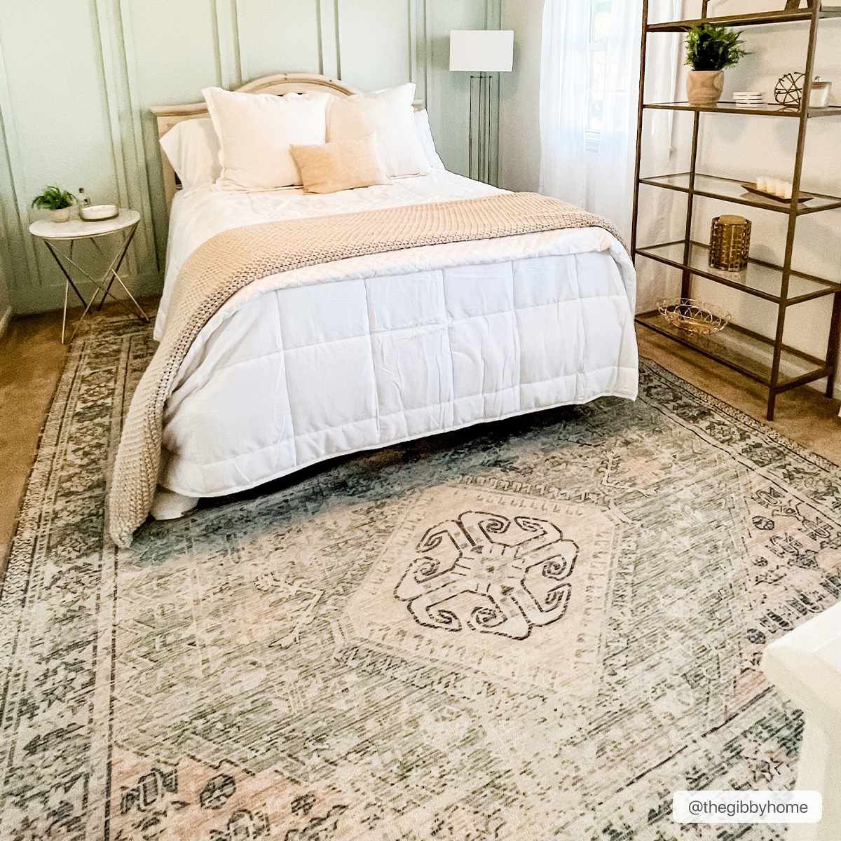 Bedroom scene with a Foraker Sage Green Cotton Rug, white bedding, and light green walls for a calming, farmhouse feel. Roomscene-Rectangle
