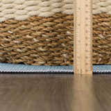 Close-up of the Petey Blue Animal Print Washable Kids Rug showing the rug's thickness with a ruler for scale. Pile