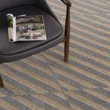 Close-up of the Webuye 3D Outdoor Area Rug. Gray geometric pattern on a light brown background. Contemporary style. Styleshot