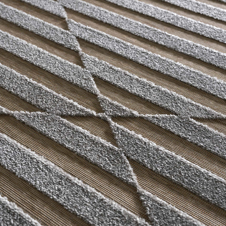 Close-up of Webuye 3D Outdoor Area Rug with a gray geometric pattern on a multi brown woven background. Texture