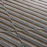 Close-up of the Webuye 3D Outdoor Area Rug showing its gray textured stripes and geometric pattern on a brown background. Texture