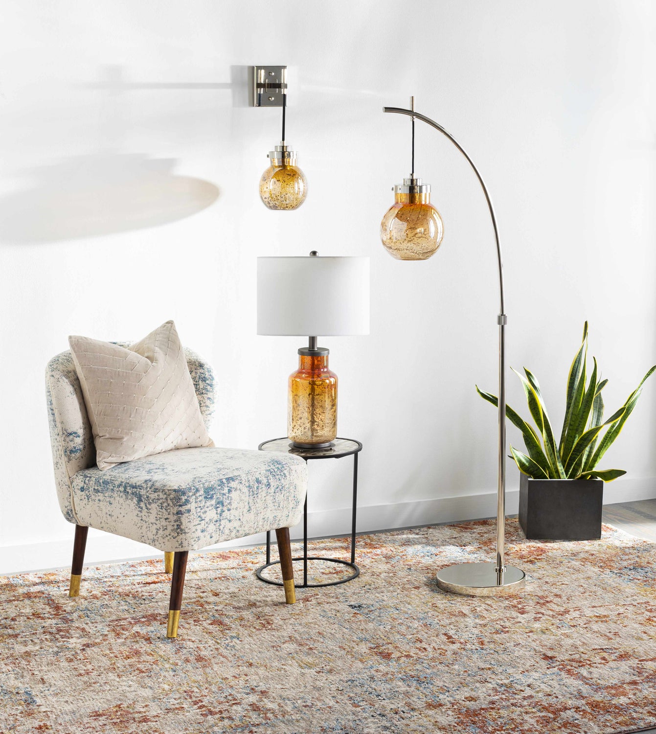 Living room scene with a chair, lamps, and the Cranfield Area Rug in brick red, cream, and blue tones. Roomscene-Rectangle