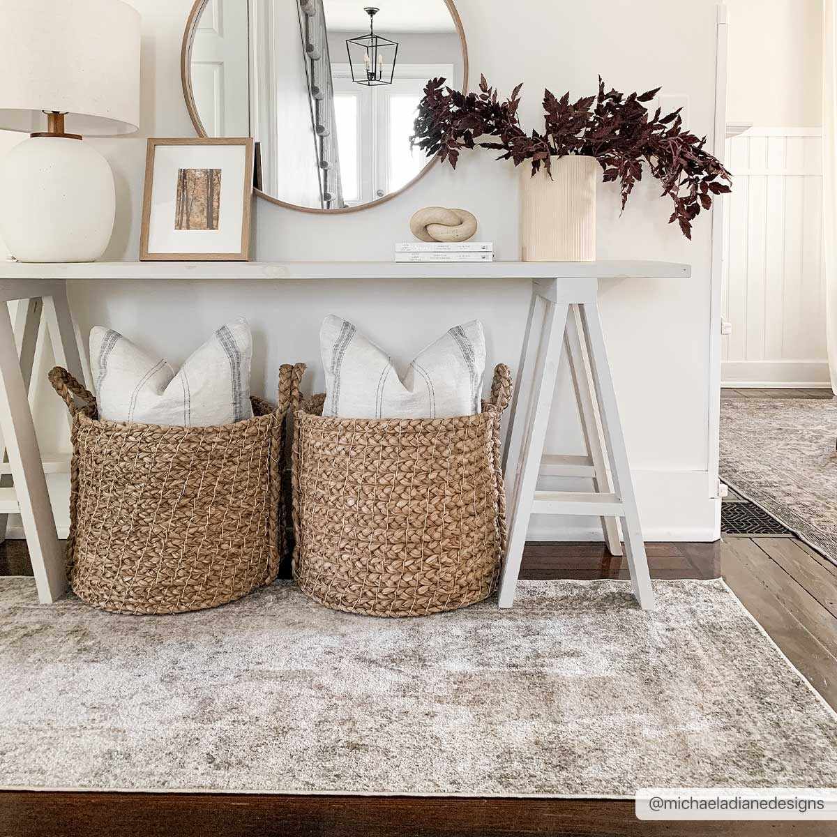 Entryway scene with a neutral console table and the Gael Boutique Washable Rug in light blue, olive, and tan. Roomscene-Rectangle