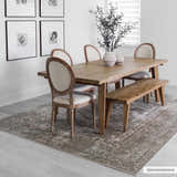 Farmhouse dining room with wood table and Gael Boutique Washable Rug in light blue, olive, tan, and yellow. Roomscene-Rectangle