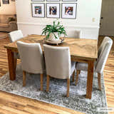 Dining room with wood table, upholstered chairs, and a light gray vintage Gael Boutique Washable Rug. Roomscene-Rectangle