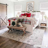 Festive bedroom scene with the beige and gray Georgiana Area Rug, white bed, and red Christmas accents. Roomscene-Rectangle
