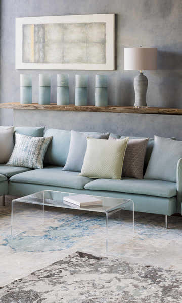 Living room scene with a light blue sofa and the charcoal, cream, and light blue Simon Area Rug. Roomscene-Rectangle
