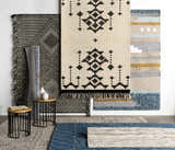 Styled rug scene with Ravendale Area Rug in cream, gray, and slate. Bohemian, contemporary rugs are displayed on a wood floor. Styleshot