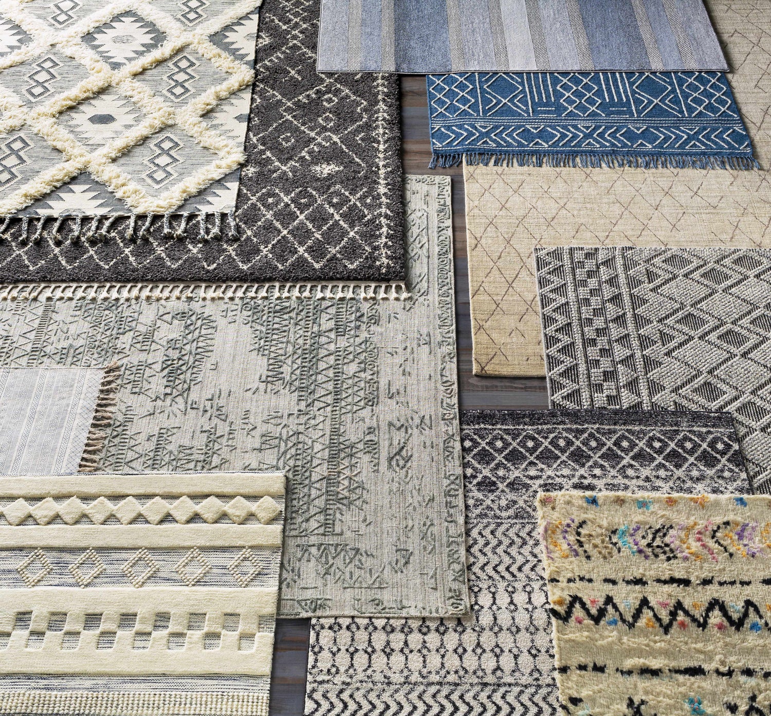Close-up of multiple Ravendale Area Rugs in cream, gray, and slate. Bohemian, contemporary, and mid-century modern styles. Styleshot