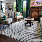 Living room with vintage decor and Gray Ecorse Zebra Print Area Rug, featuring chairs, a fireplace, and dark green accents. Roomscene-Rectangle