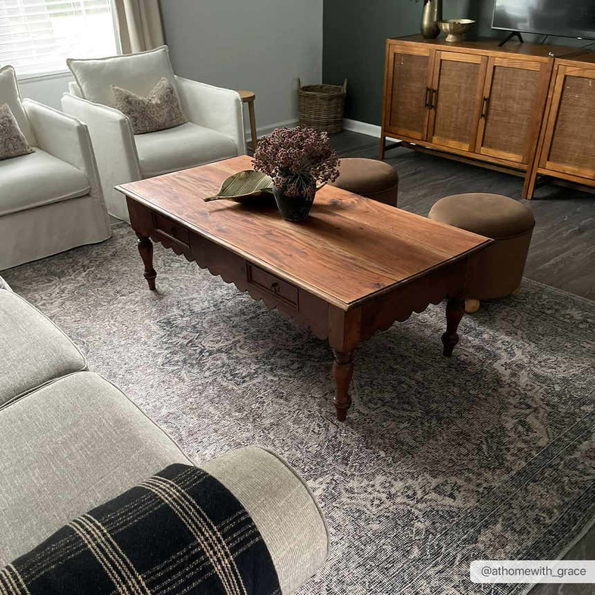 Living room scene with a Greenpoint Dusty Blue Washable Rug, wood coffee table, white armchairs, and a gray sofa. Roomscene-Rectangle