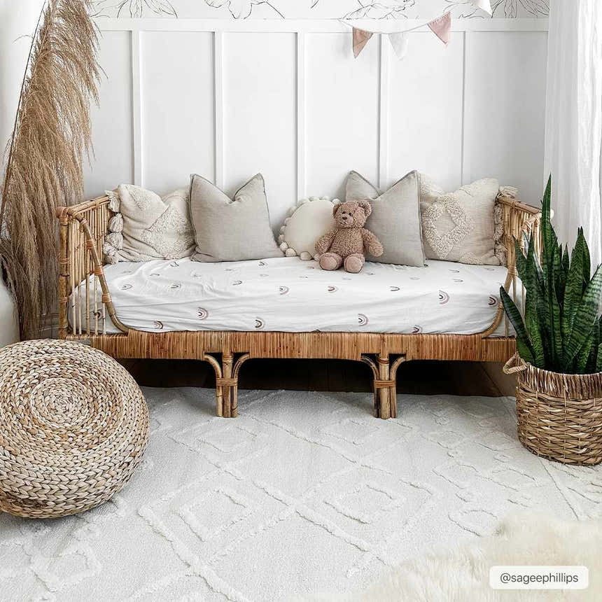 Neutral kids room with a rattan daybed on the bone-colored geometric Gyundyukoru Area Rug. Roomscene-Rectangle