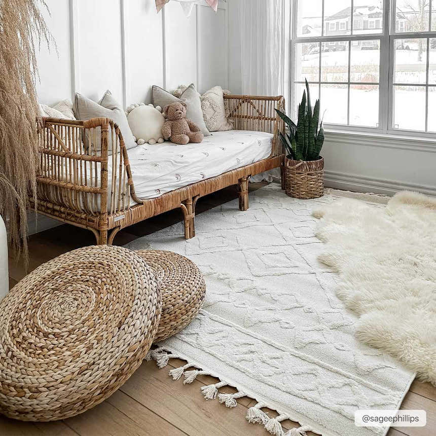 Bright kids room with rattan daybed, woven poufs, and geometric Gyundyukoru Area Rug in bone and cream. Roomscene-Rectangle