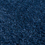Close-up of the plush texture of the Faina Solid Dark Blue Shag Washable Area Rug, showing its soft, dense fibers. Texture