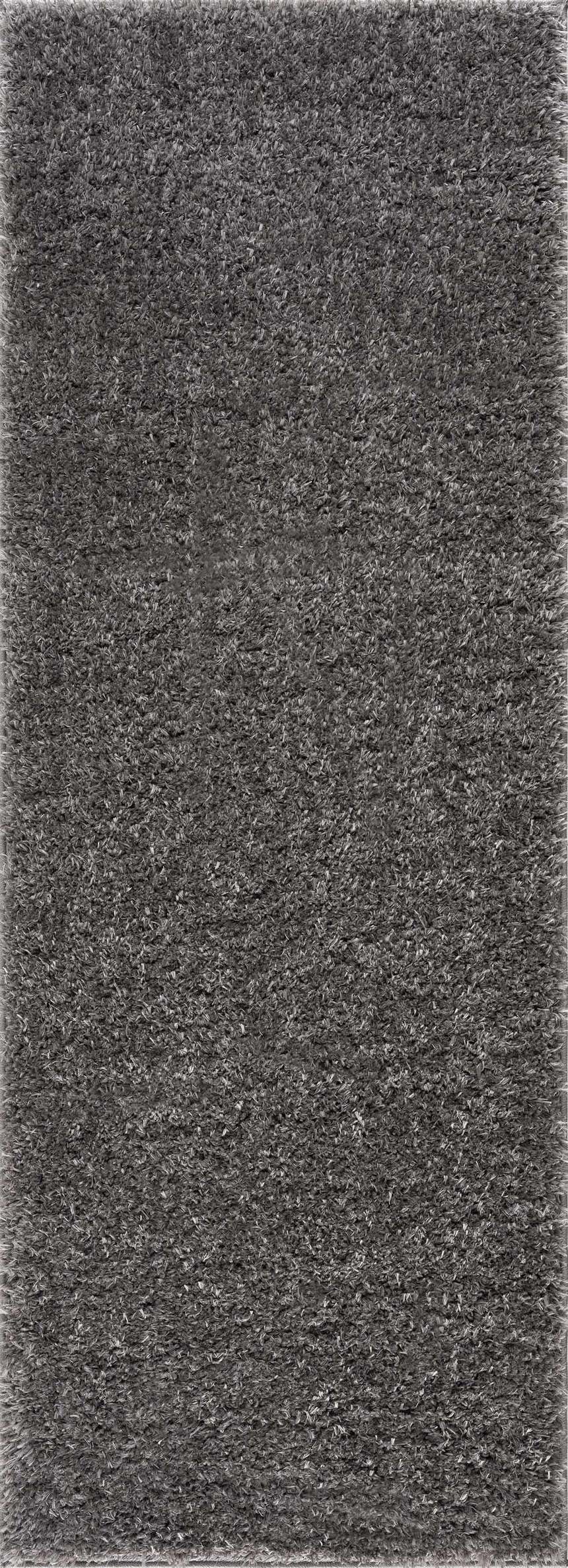 Close-up of the plush texture of the Faina Solid Dark Gray Shag Washable Area Rug. Design-Runner