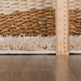 Close-up of Faina Solid Beige Shag rug showing texture, pile height, and construction details with a ruler for scale. Pile