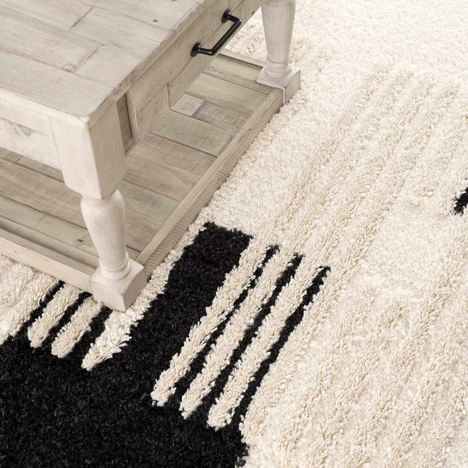 Close-up of the Astro Modern Shag Area Rug in driftwood and onyx black, with a shaggy texture and geometric stripe design. Styleshot