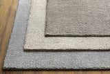 Close-up of the Pantubig Area Rug showing texture and color variations: charcoal, gray, ivory, and light beige. Styleshot