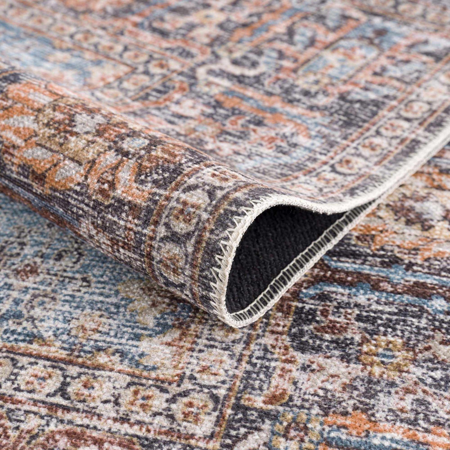 Close-up of the Blue Burgundy Holi-2302 Washable Area Rug showing its Persian-inspired design, soft texture, and color palette. Fold