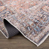 Close-up of Blue Burgundy Holi-2302 rug showing its Persian-style design, beige, blue, and burgundy colors, and machine-printed texture. Fold