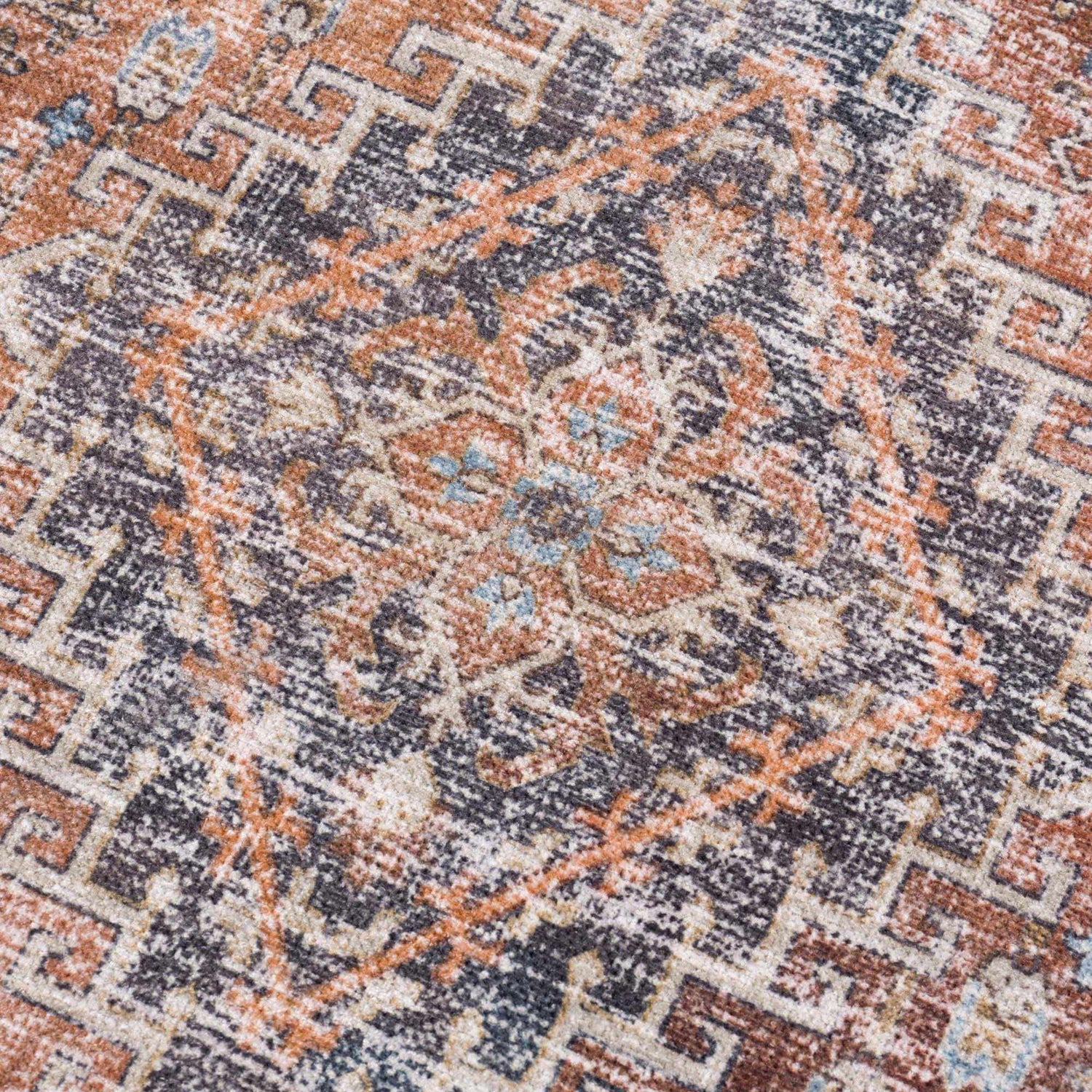 Close-up of Blue Burgundy Holi-2302 rug. Beige, burgundy, and orange hues create a vintage Persian pattern. Washable polyester texture. Texture