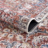 Close-up of the Burgundy Holi-2303 Washable Area Rug showing its burgundy, cream, and blue vintage-style pattern and soft texture. Fold