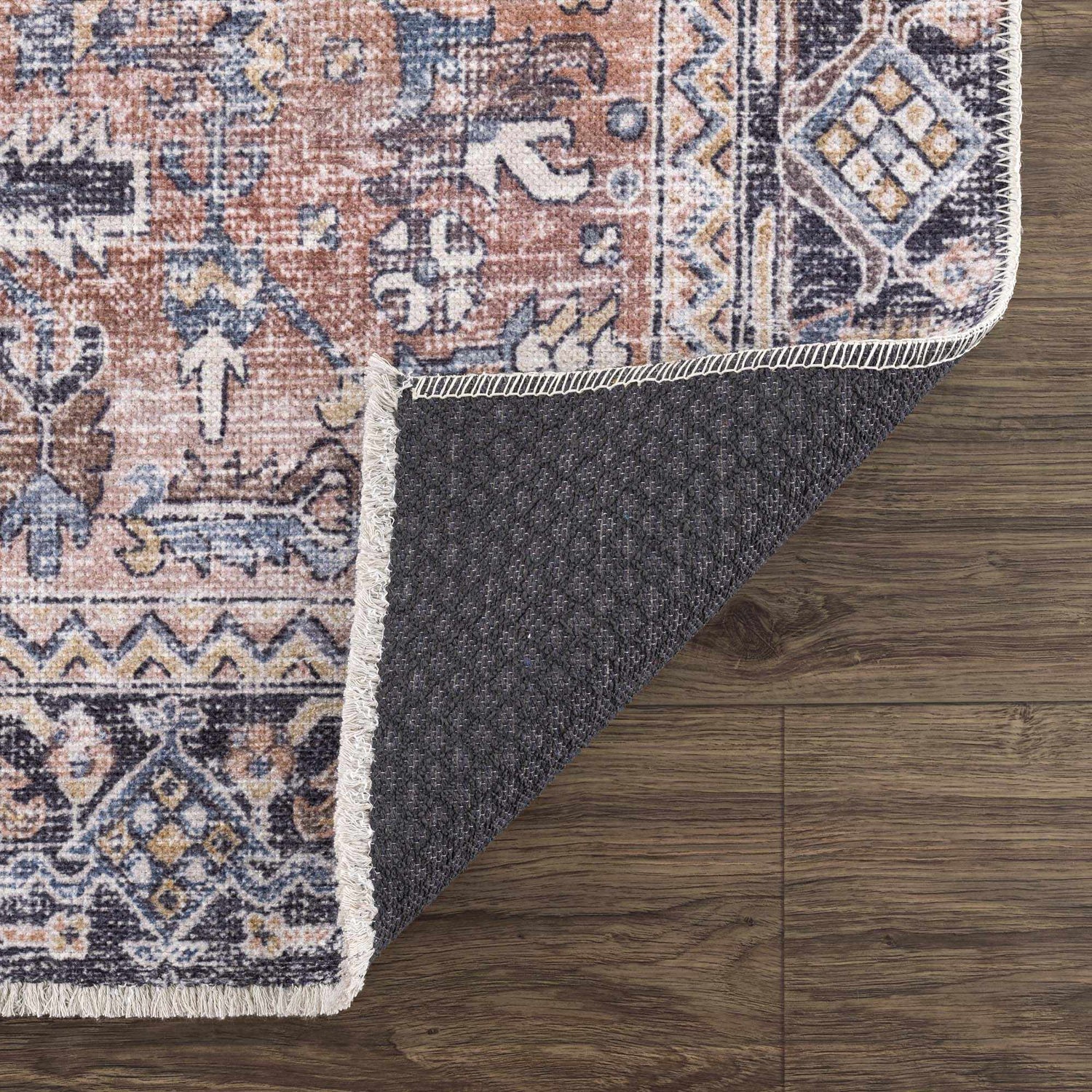 Close-up of the Holi-2305 Boutique Washable Rug showing its burgundy, cream, and blue traditional pattern and non-slip backing. Fold