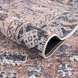 Close-up of the Holi-2305 Boutique Washable Rug. Features burgundy, cream, and slate hues in a traditional, vintage-inspired pattern. Fold