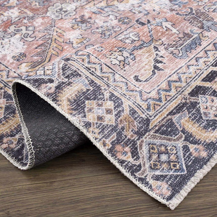 Close-up of the Holi-2305 Boutique Washable Rug. Features a traditional, vintage design in burgundy, cream, and slate colors. Fold