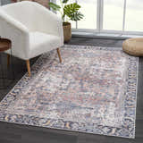 Living room scene with a cream chair and the vintage-style Holi-2305 Boutique Washable Rug in burgundy, cream, and blue tones. Roomscene-Rectangle