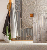 Scandinavian mudroom scene with Wauzeka Premium Area Rug, cactus plants, and textured wall art. Styleshot