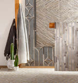Modern mudroom scene with brown, cream, and gray Wauzeka Premium Area Rug, cactus, and textured wall art. Styleshot
