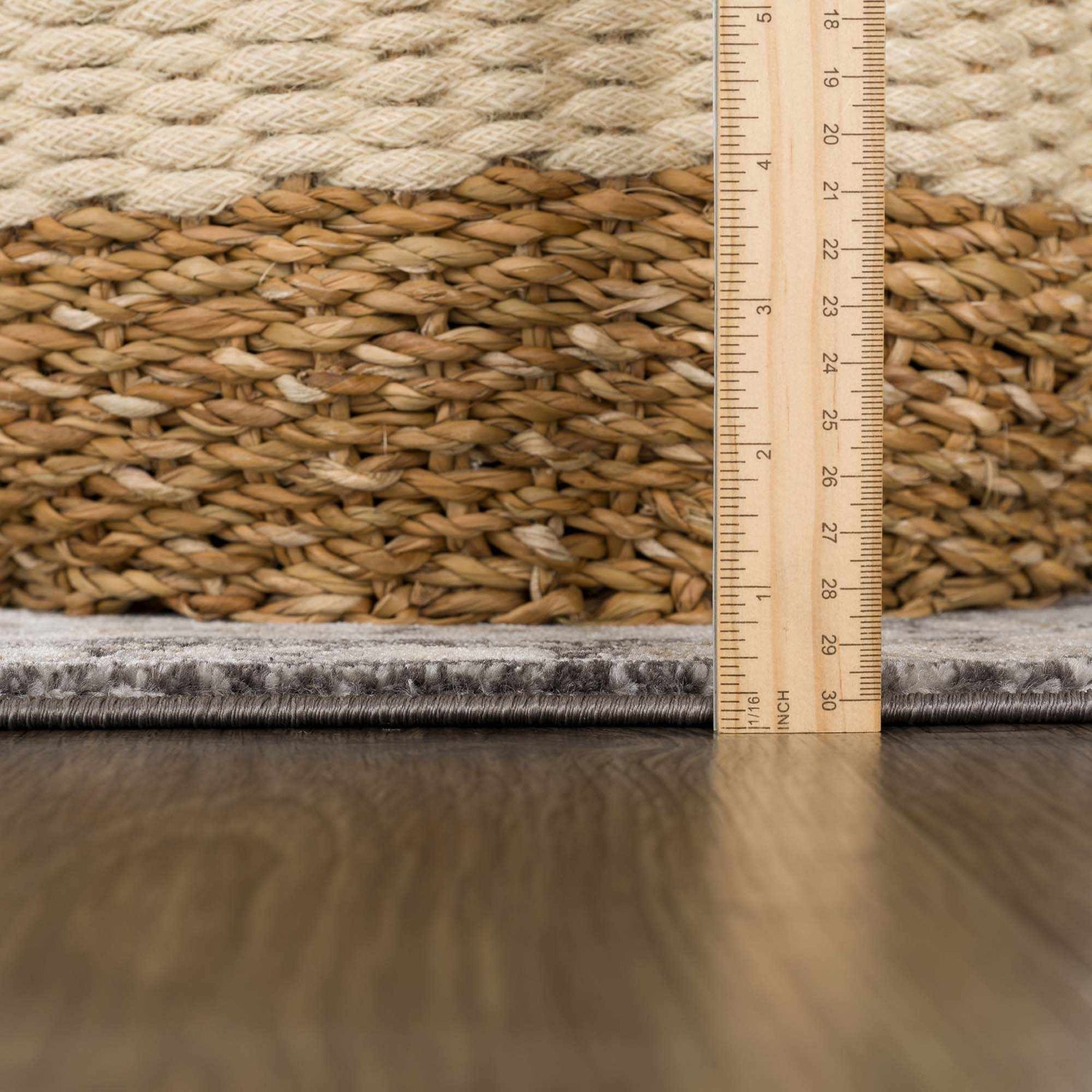 Close-up of the Minoa Area Rug showing the pile height and construction details with a ruler for scale. Pile