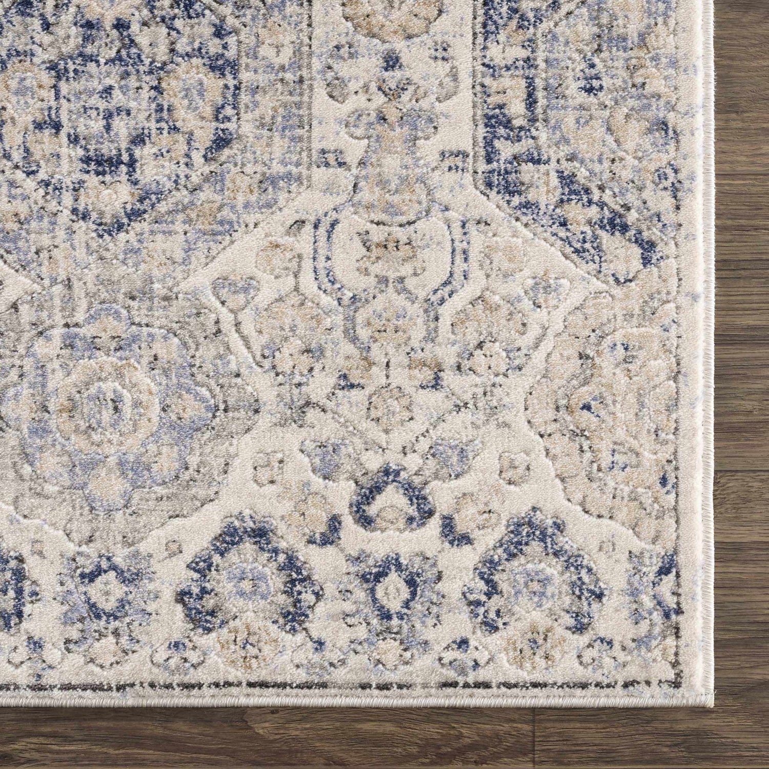 Close-up of the Parkerfield Cream & Blue Area Rug showing its traditional floral pattern and soft, textured weave. Swatch