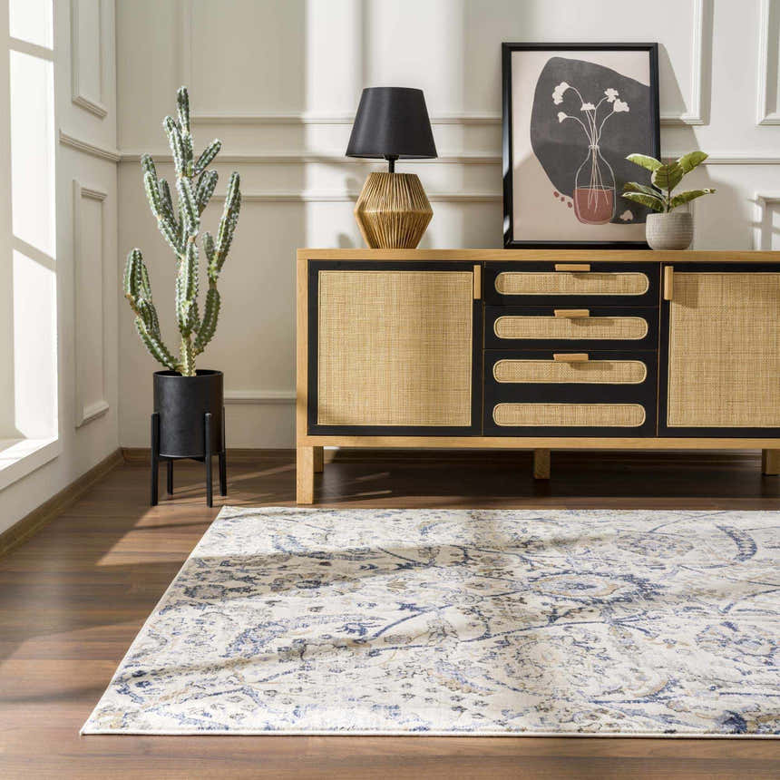 Living room scene with a Georgiana Blue & Beige Oushak Rug, wood floors, and a natural wood and black sideboard. Roomscene-Rectangle