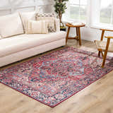 Living room scene with a red and blue Neyland Area Rug, beige sofa, and wood accents. Roomscene-Rectangle