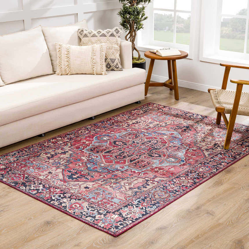 Living room scene with a red and blue Neyland Area Rug, beige sofa, and wood accents. Roomscene-Rectangle