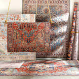 Display of Selbyville Area Rugs. Bohemian and Oriental styles in brick red, emerald, ivory, and blue. Machine woven texture. Styleshot