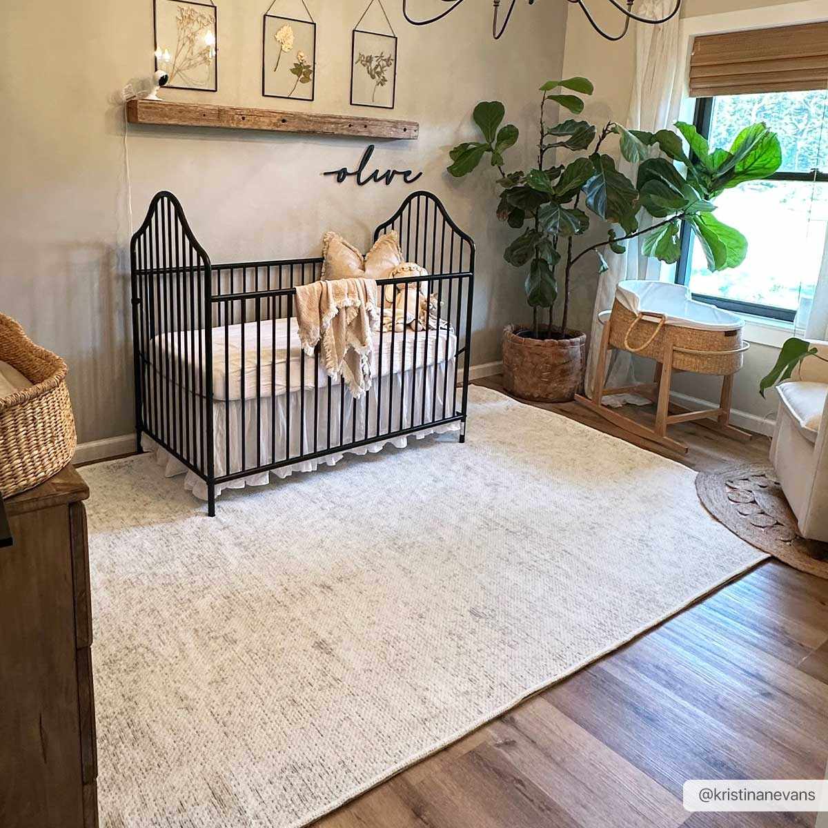 Nursery with cream walls, black crib, and Isako Cream & Gray Solid Washable Area Rug on wood floors. Roomscene-Rectangle