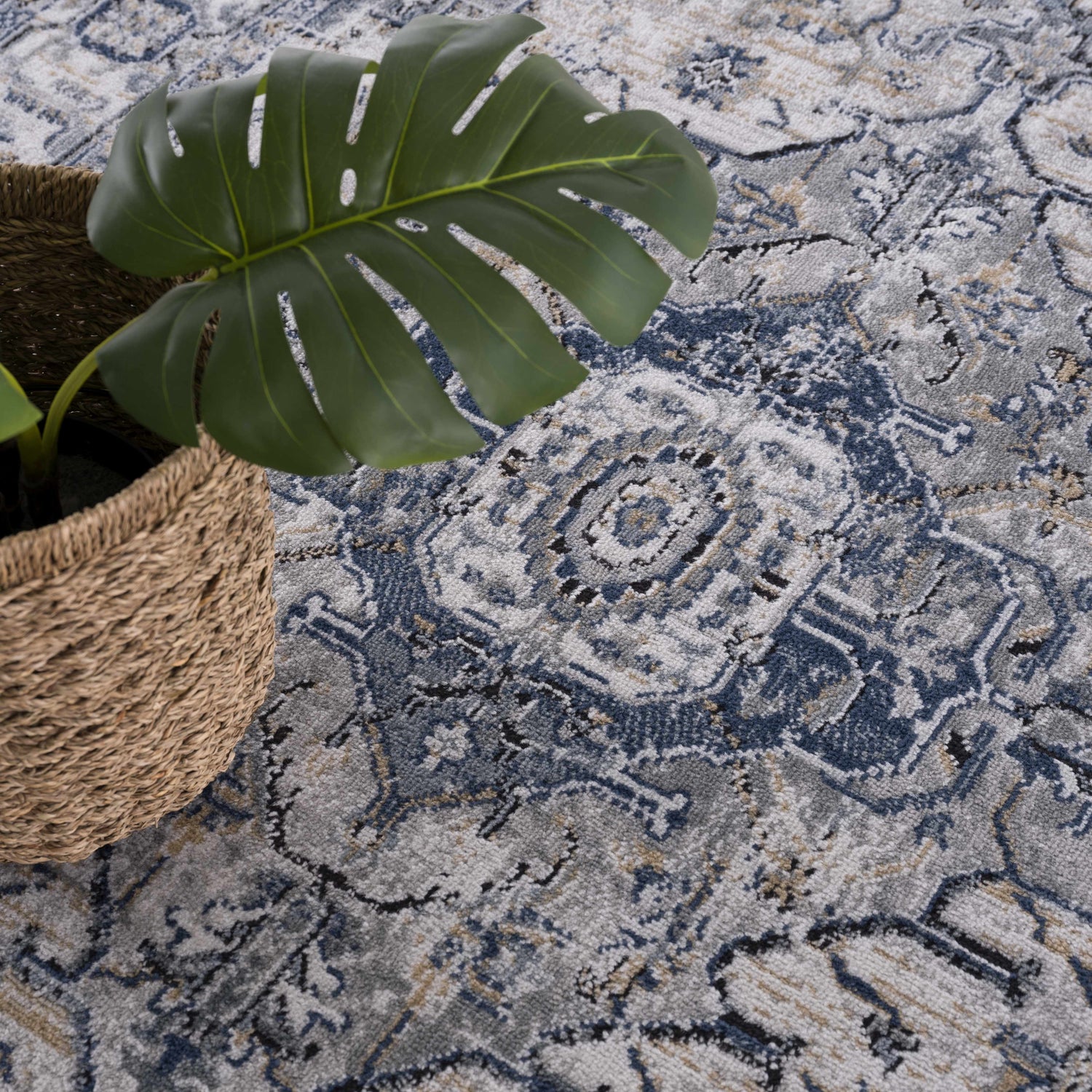 Close-up of the Murrindindi Area Rug featuring a blue, cream, and gray traditional pattern with a textured, machine-woven construction. Styleshot