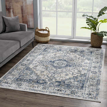Living room scene with a gray sofa and the blue and cream Murrindindi Area Rug on a wood floor. Roomscene-Rectangle