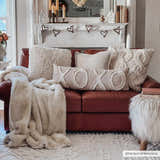 Living room scene with ivory Kalkan High/Low Pile Rug, brown leather sofa, and cozy neutral pillows and throw. Farmhouse style. Roomscene-Rectangle